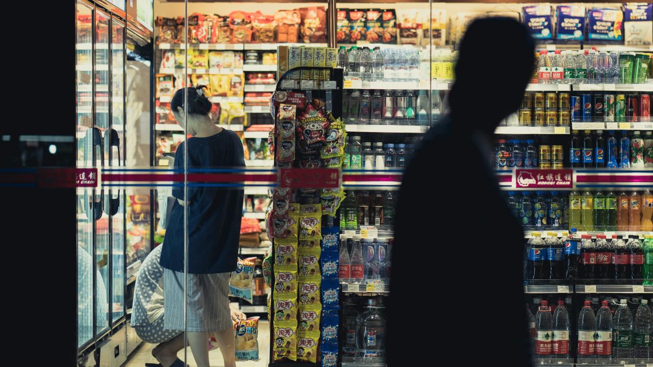 Grocery products on shelves with customers