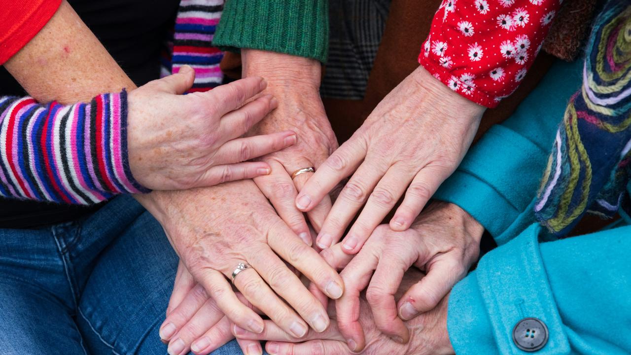 Hands linked together