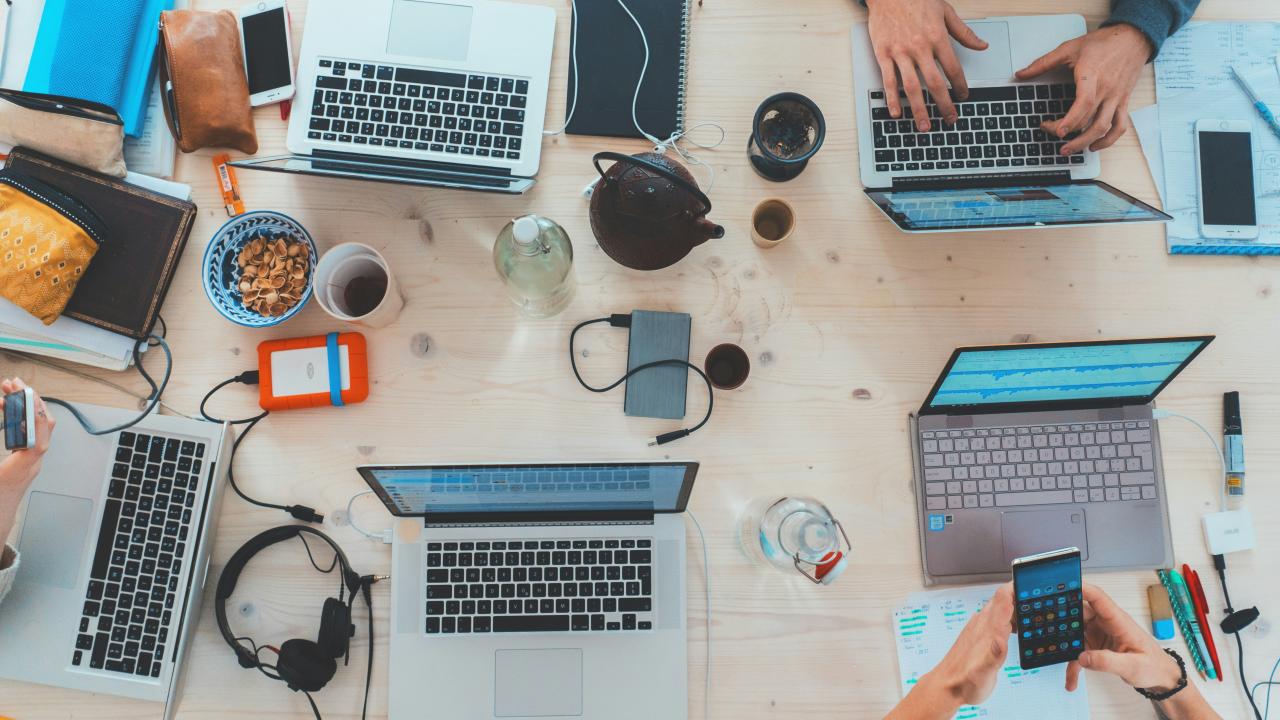 multiple laptops on a desk