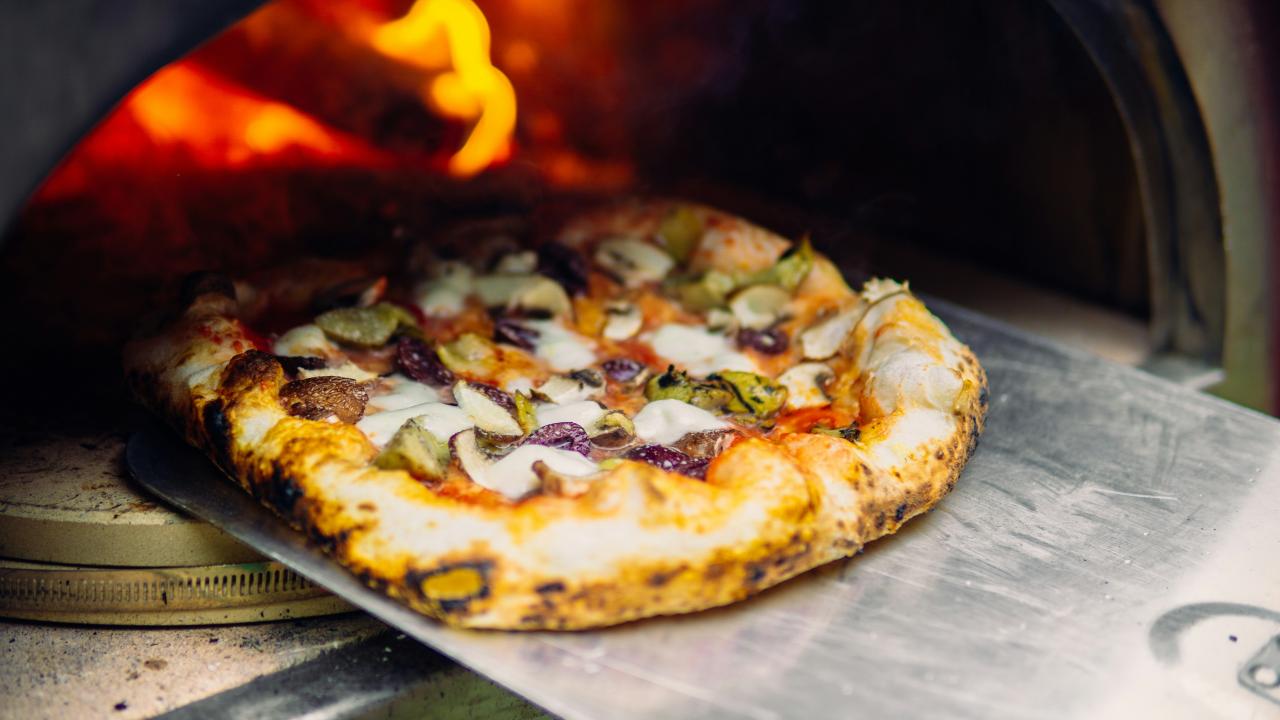 pizza coming out of the oven