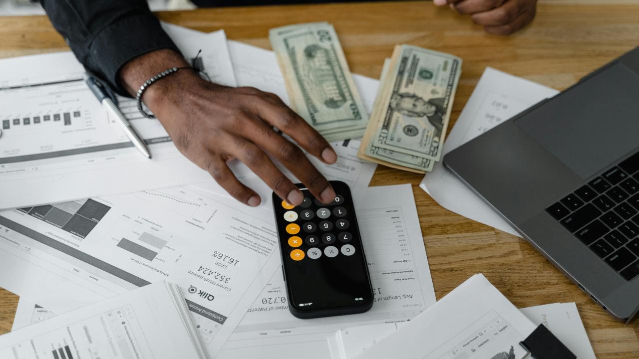 A stock photo of a calculator and money 