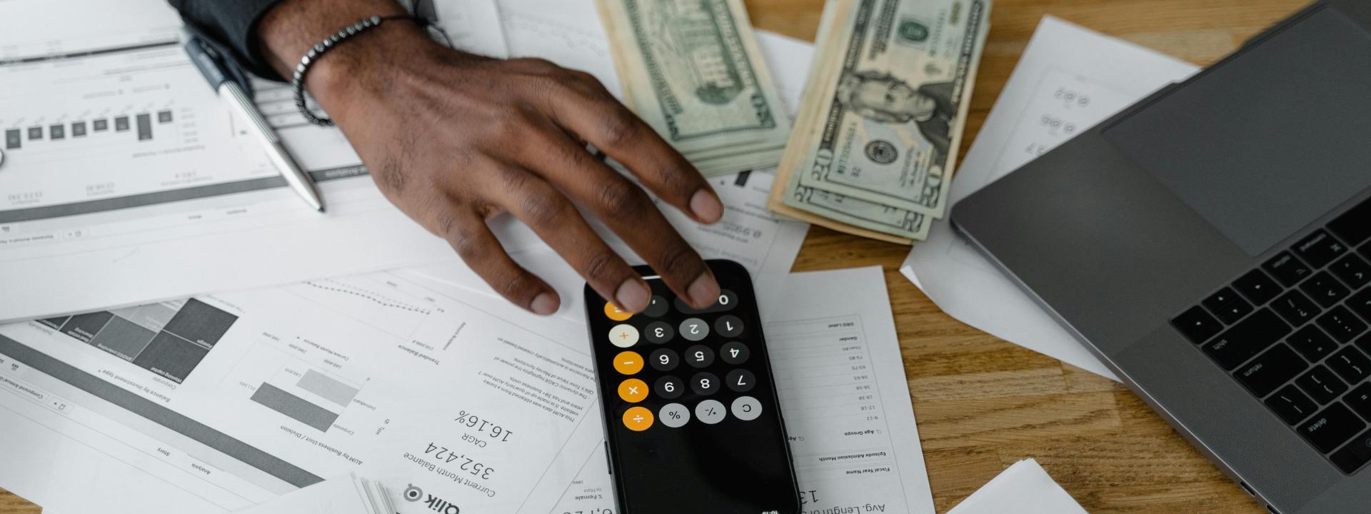 A stock photo of a calculator and money 