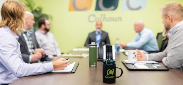 A group of people sitting at a conference table