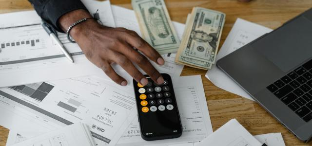 A stock photo of a calculator and money 